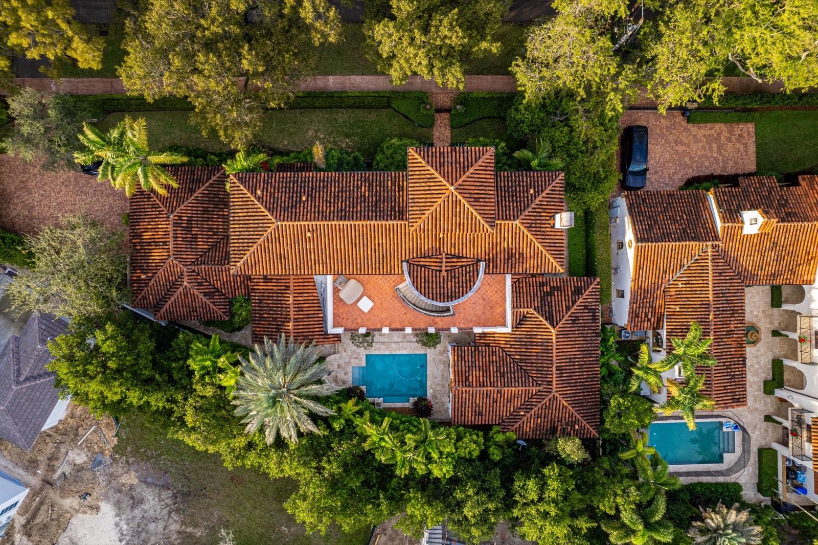 Overhead view of a Florida home's barrel tile roof, showing hips, valleys and penetrations